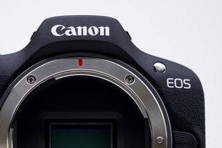 A Canon Inc. EOS R100 mirrorless digital camera on display at the CP+ Camera and Photo Imaging Show in Yokohama, Japan,
