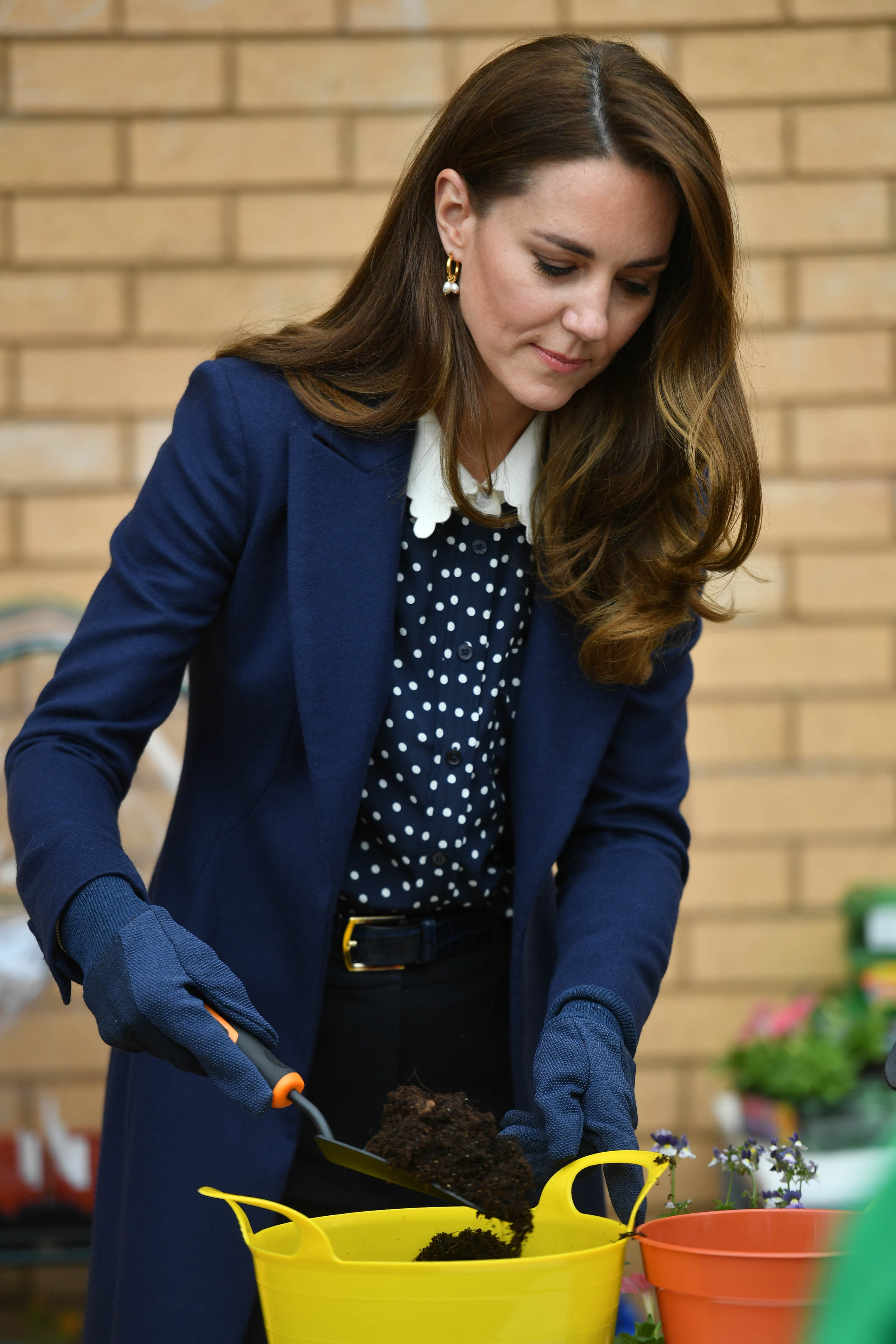 Catherine, Duchess of Cambridge pots a plant during a visit to The Way Youth Zone on May 13, 2021 in Wolverhampton, England. (Photo by Jacob King - WPA Pool/Getty Images)