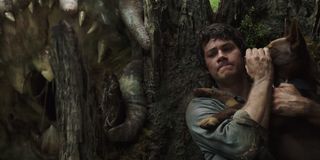 Love and Monsters Dylan O'Brien trying to keep his dog quiet near a monster