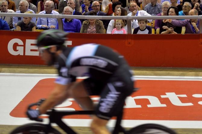 Mark Cavendish speeds by his watching family