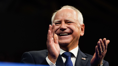 Tim Walz applauds during a campaign event at Temple University's Liacouras Center in Philadelphia, Pa., on Tuesday, Aug. 6, 2024