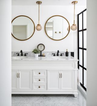 White bathroom with a white vanity unit and marble countertop