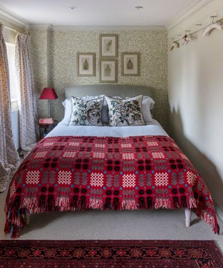 bedroom with wallpaper and cushion on bed