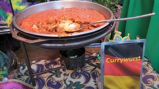 Currywurst in a serving dish at Universal Mardi Gras 2024.