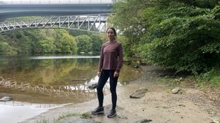 A woman standing next to a river