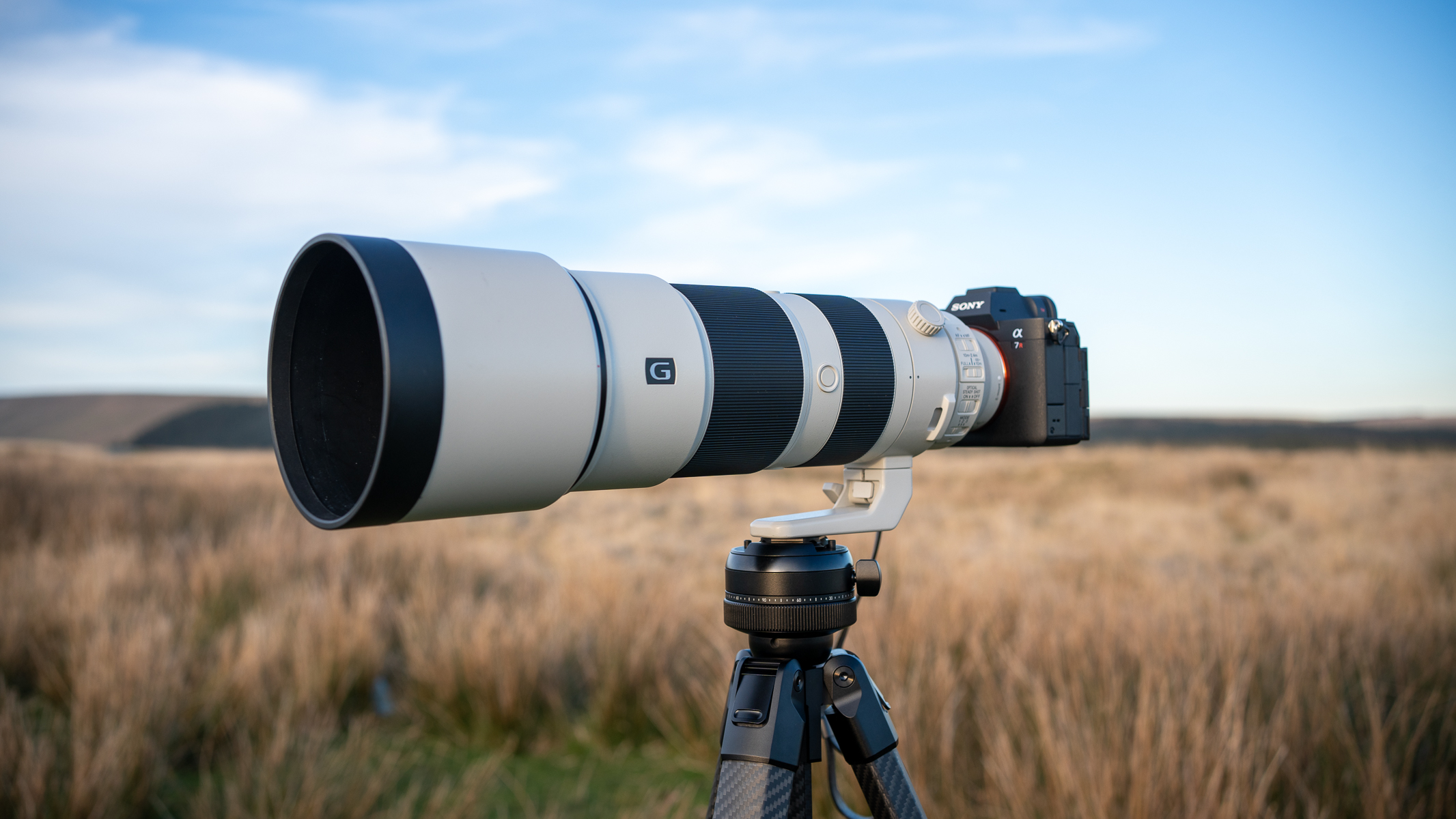Sony FE 200-600 f/5.6-6.3 G OSS on a tripod in a field