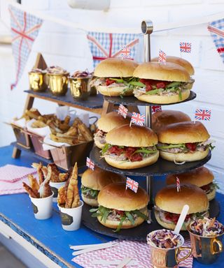 pile of burgers and other food for garden party