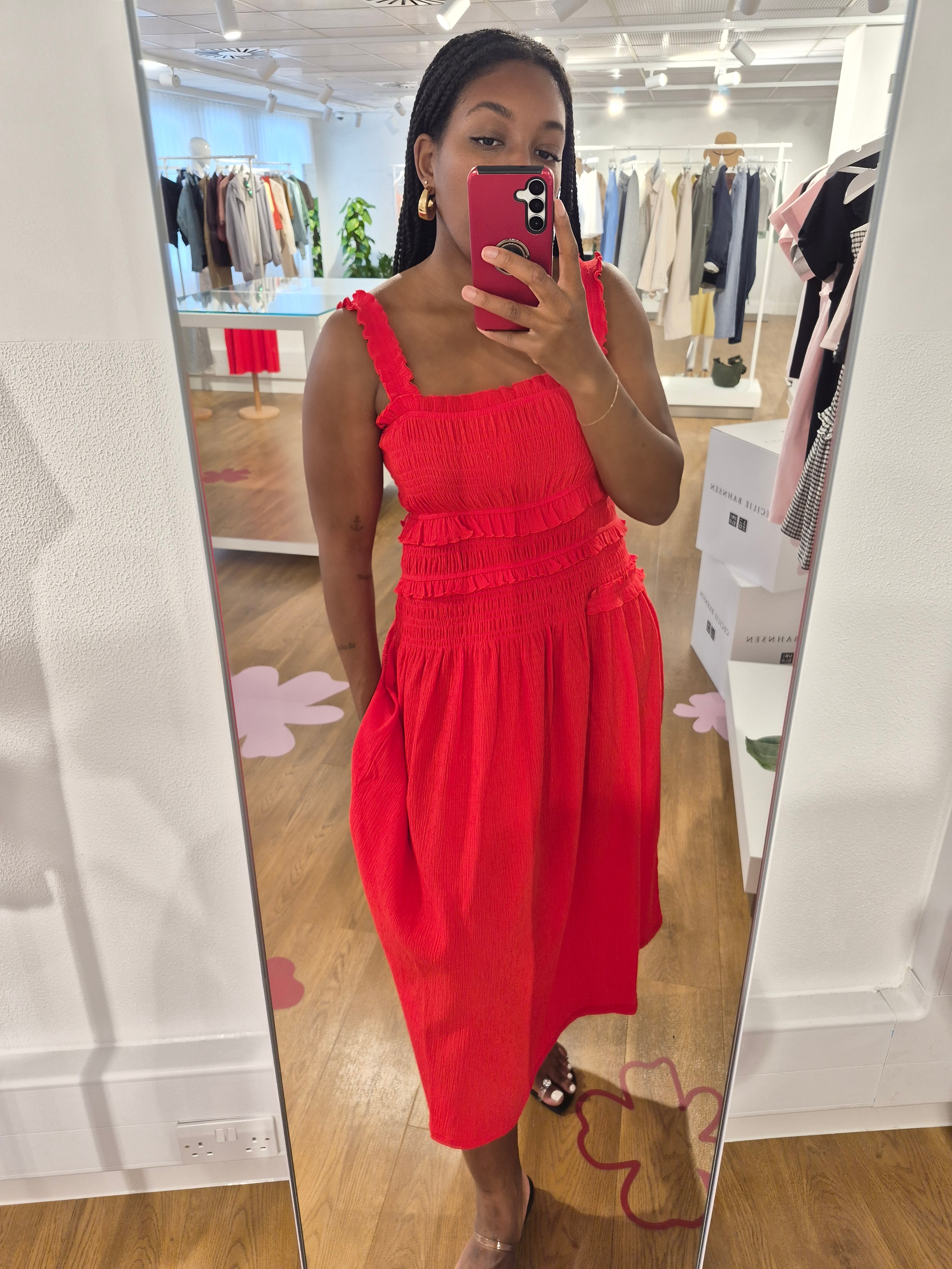 Remy is wearing a red dress