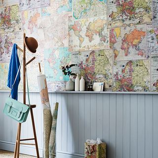 hallway with map on wall and hanging bags