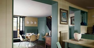 kitchen and dining room with sage green painted feature walls
