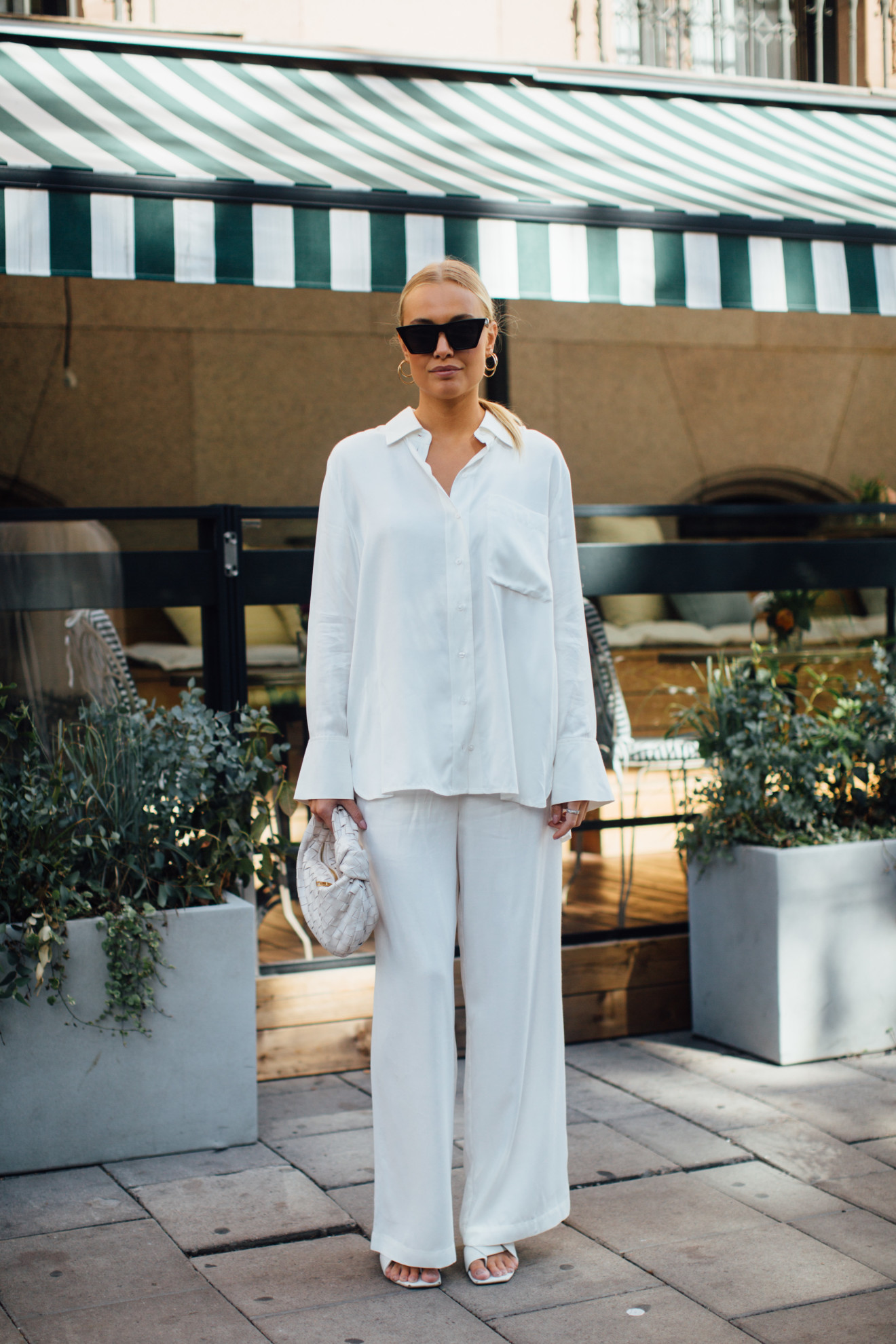 woman wearing white button-down shirt and white linen pants