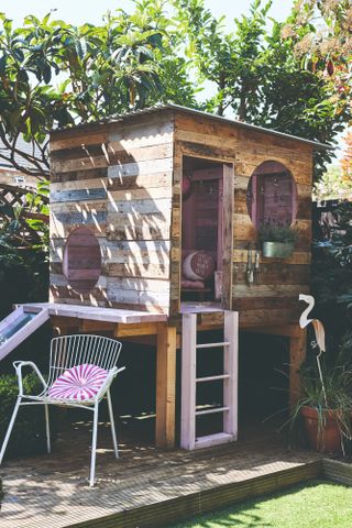 Spillett house: playhouse built with palette boards with pink ladder