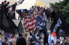 Protesters destroy and American flag in Cairo.