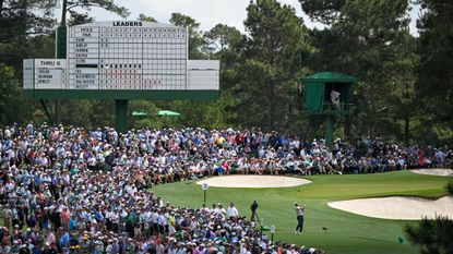 Crowds watch as Scottie Scheffler takes a shot off the third tee at The Masters