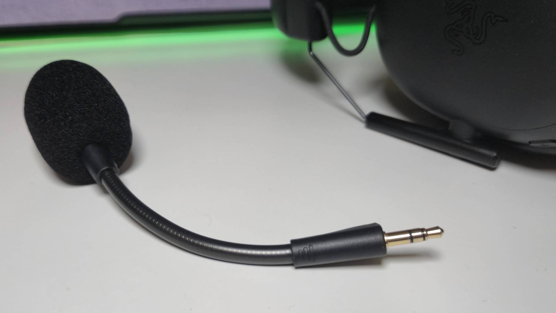 Photo by Rosalie Newcombe of the microphone of the BlackShark V3 mic sitting on a white desk.