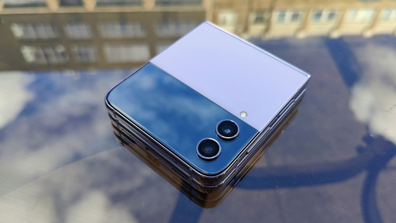 Samsung Galaxy Z Flip 4 review: phone folded up on a table with reflections of clouds