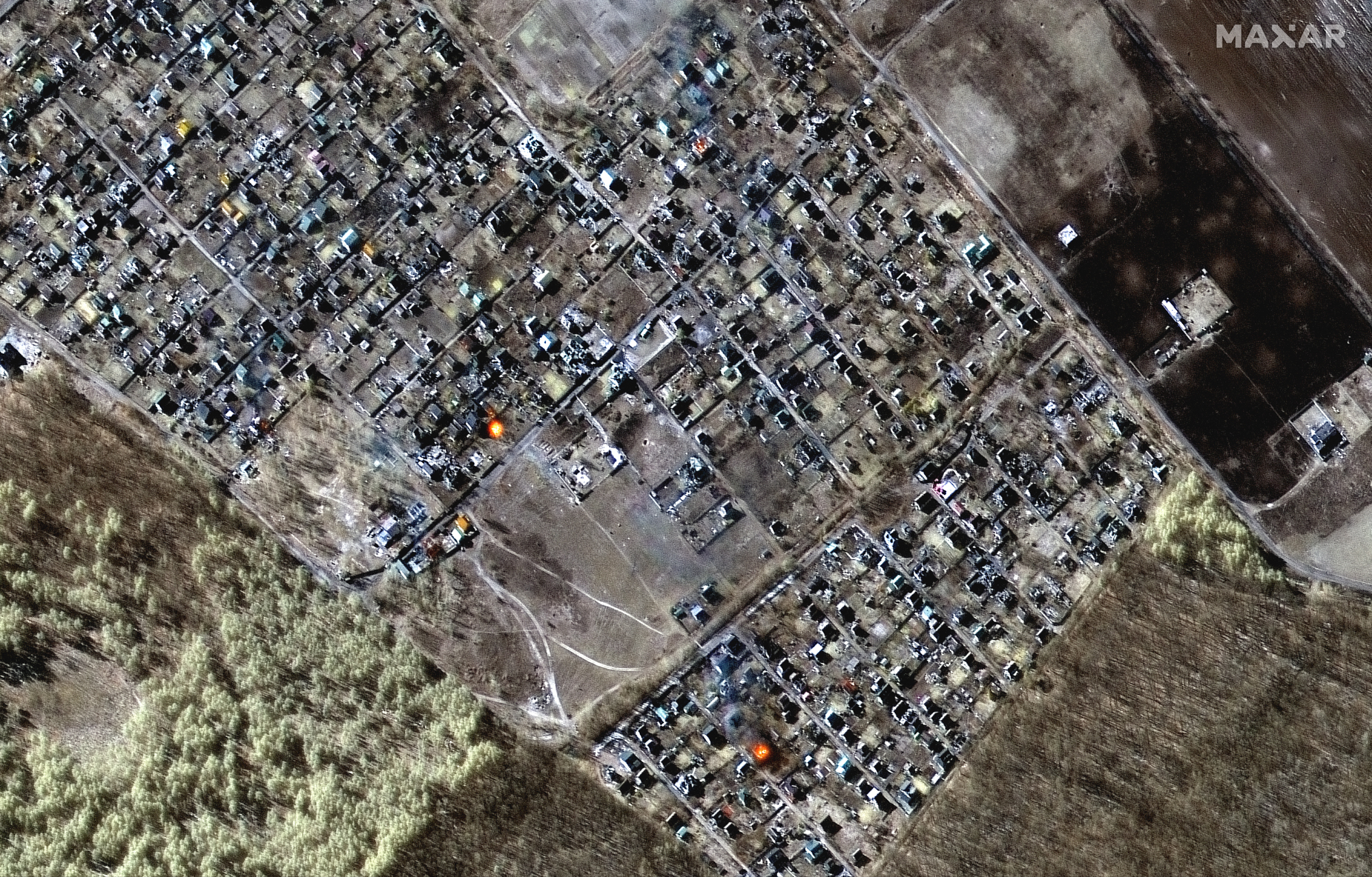 Multispectral and natural color images showing destroyed homes, impact craters and fires in town of Moschun on March 11, 2022 as seen by the WorldView-2 satellite for Maxar Technologies.