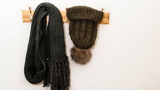 Wool hat hanging up on wall rack