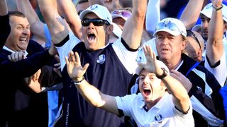 Lee Westwood and Rory McIlroy celebrate after watching Martin Kaymer of Europe holes the putt that retained the Ryder Cup at Medinah in 2012