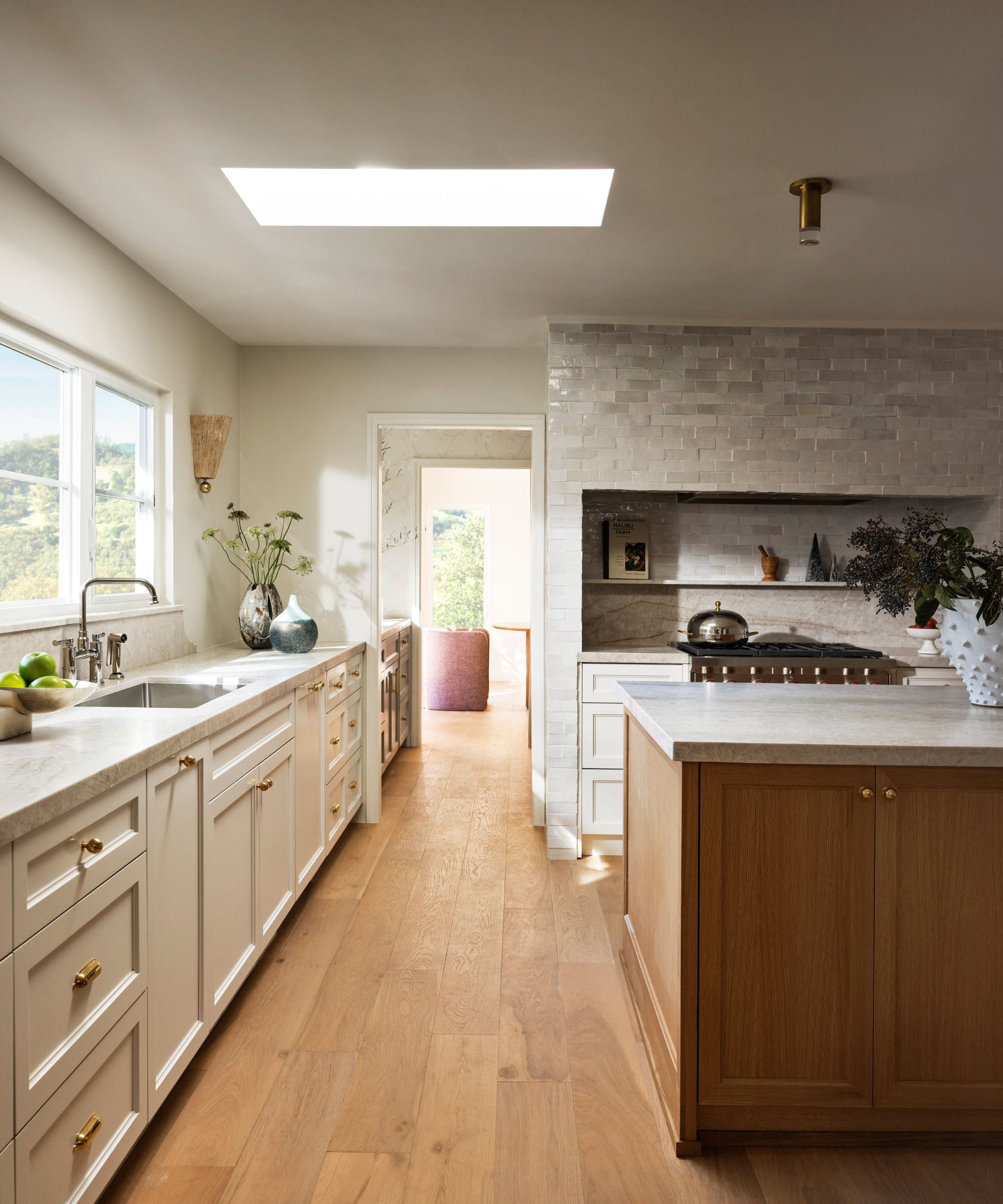 neutral kitchen with warm white walls and cabinets and wood floors