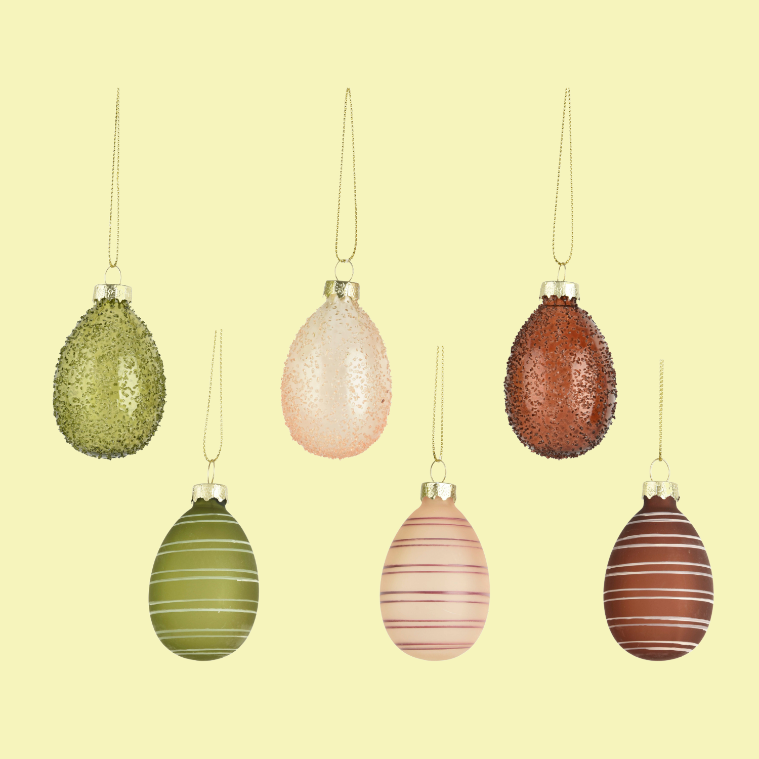 A set of six green, brown, and peach glass Easter ornaments