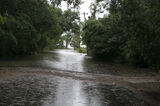 An American Road Is Flooded With Water After A Tropical Storm - stock photo