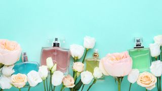 Perfume bottles on a blue background with flowers