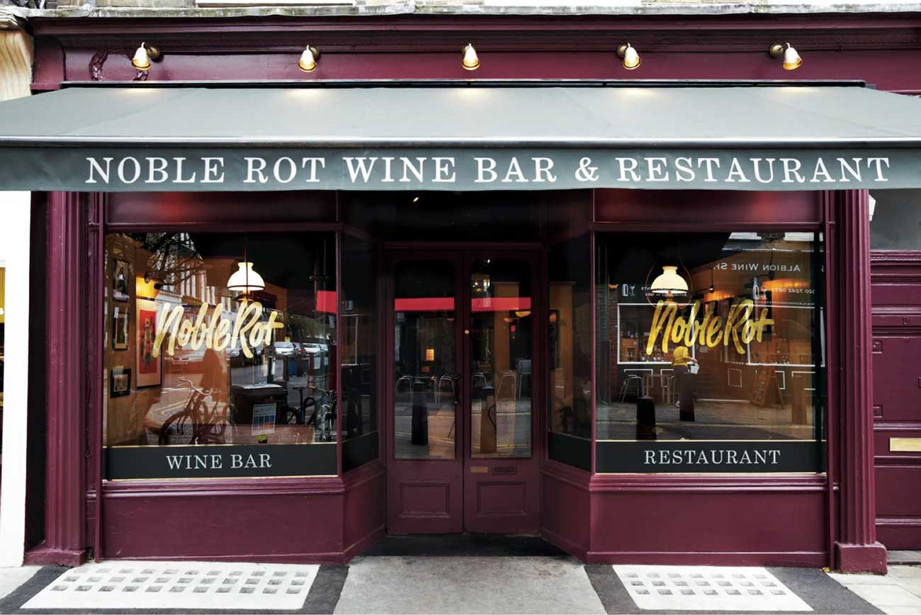 The front windows of a wine bar overlooking the street