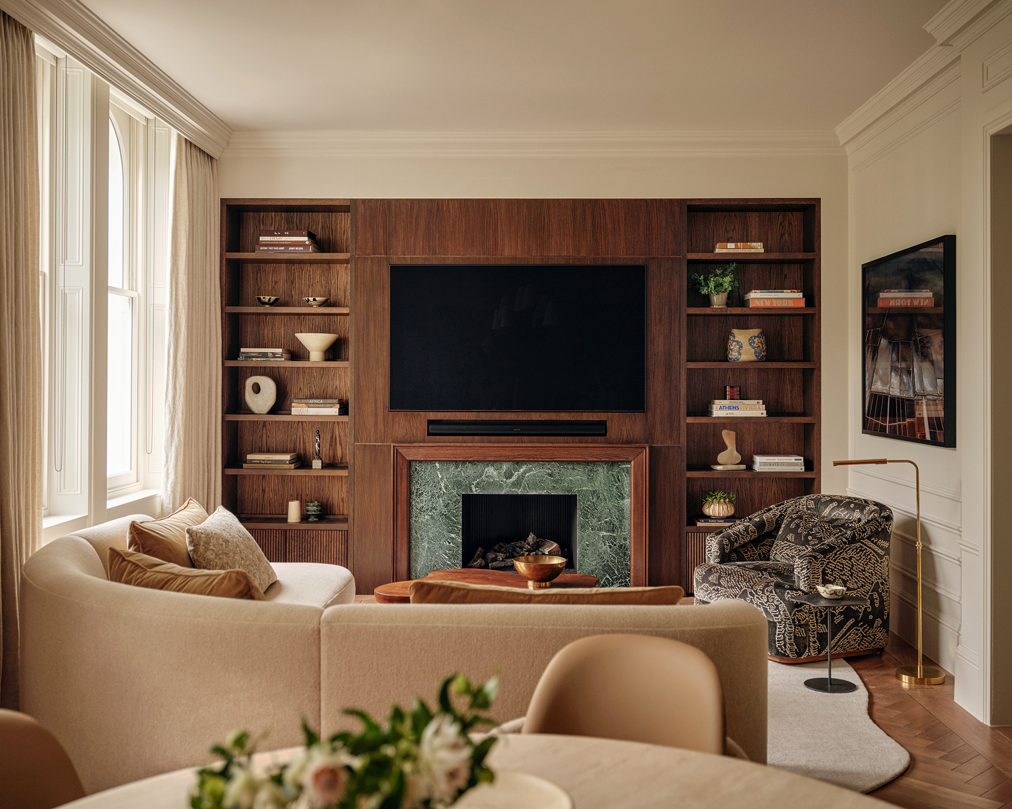 living room with curved white sofa and wood panneling
