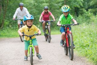 A family group riding bikes