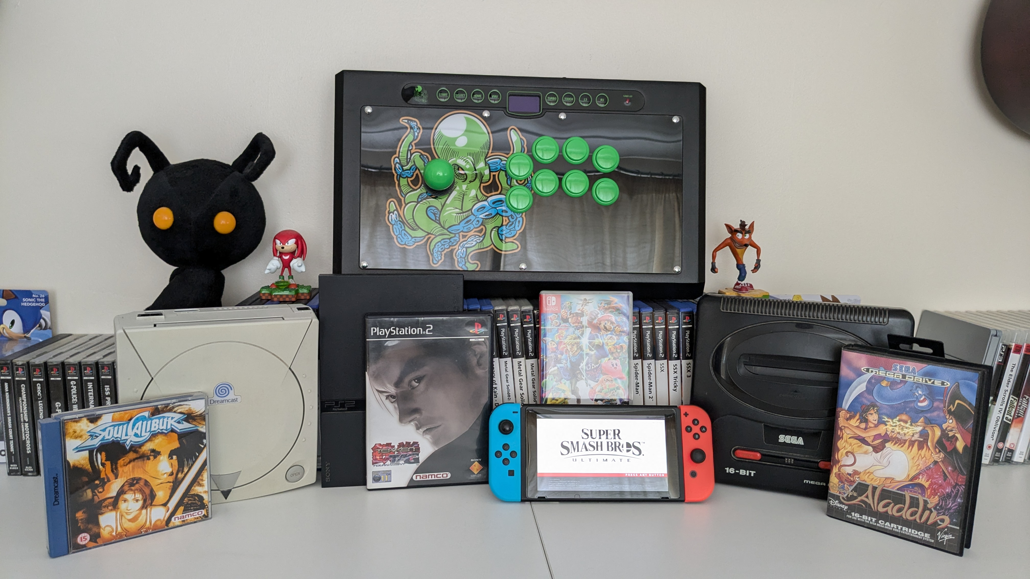 An image of the Octopus Arcade Stick among retro games consoles and games, and a Nintendo Switch