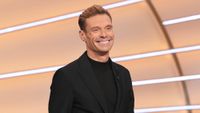 Ryan Seacrest smiling hosting Wheel of Fortune 