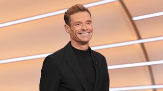 Ryan Seacrest smiling hosting Wheel of Fortune 