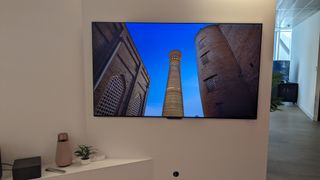 LG M4 OLED TV with building on screen