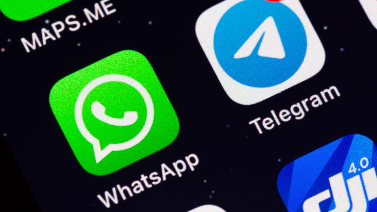WhatsApp and Telegram app icons on display of an iPhone - stock photo