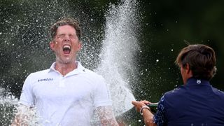 Niklas Norgaard is sprayed with champagne after winning the Betfred British Masters title