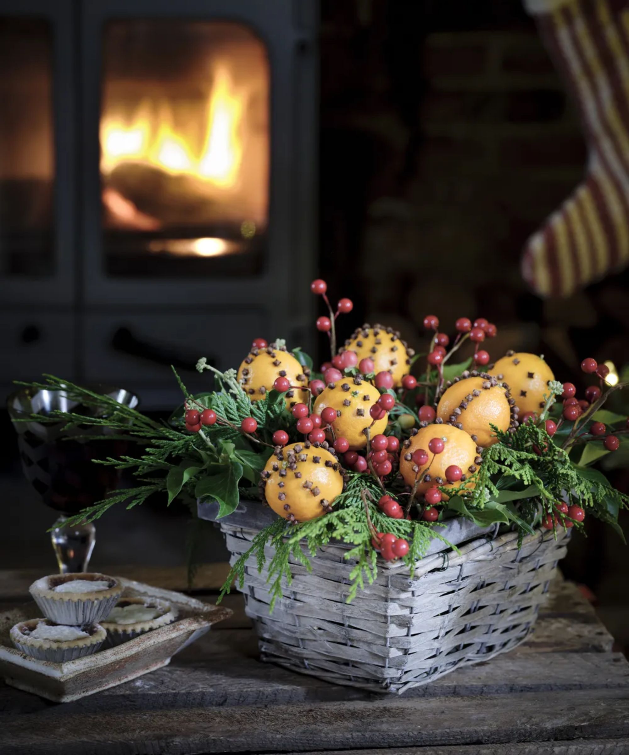 Wicker basket filled with festive foliage and pomander ball decorations