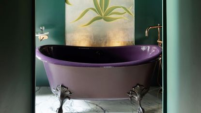 A purple bathtub in a green bathroom