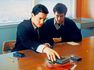 Agent Cooper (Kyle MacLachlan) and Sheriff Harry S. Truman (Michael Ontkean) investigate the death of local teen Laura Palmer, in the 1990 ABC series "Twin Peaks."