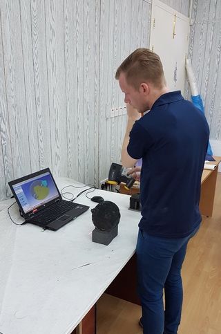 A researcher examines a scan of the astrolabe.