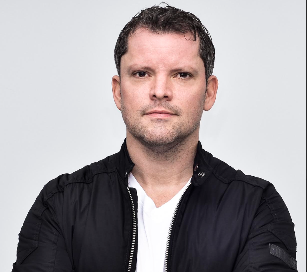 a man in a white t-shirt and black jacket