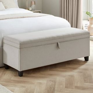 DUSK Ottoman Storage Bench in a bedroom at the foot of a bed