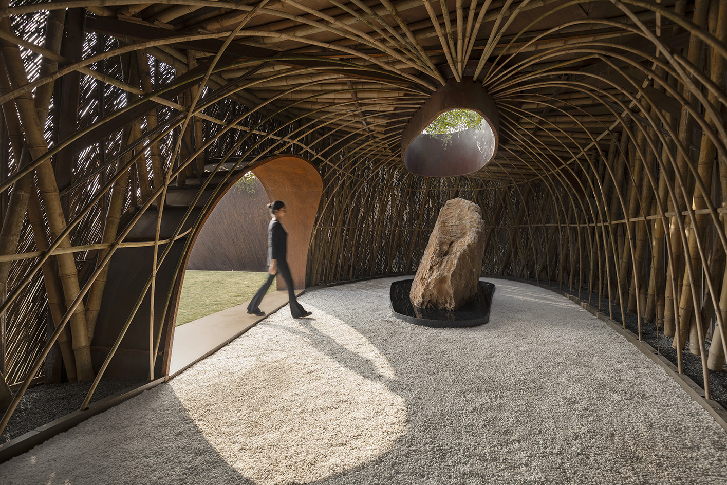 The Aranyani Pavilion seen in its green setting that highlights its natural materials and organic construction