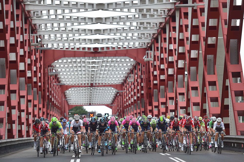 The peloton crosses a bridge during stage 2.