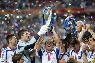 Greece players celebrate with the European Championship trophy after winning Euro 2004.