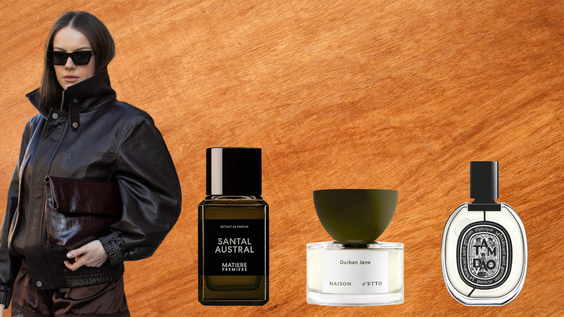 A woman wearing a brown leather jacket next to three bottles of sandalwood perfume. All are in front of a wooden background. 