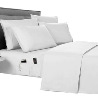 A white bedding set with a gray headboard