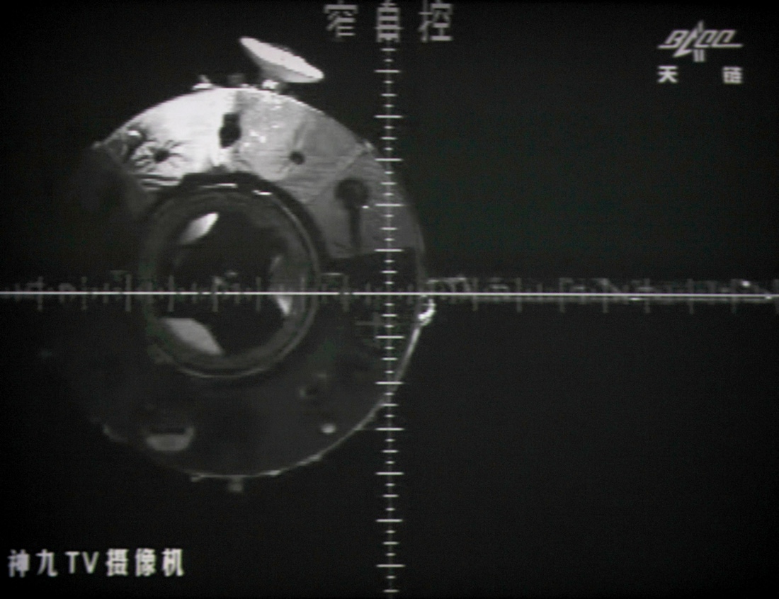 A giant screen at the Jiuquan space center shows the Tiangong-1 space lab from a camera in the Shenzhou-9 spacecraft before the automatic docking on July 18, 2012. The Chinese space lab is expected to re-enter our atmosphere between March 30 and April 2, 