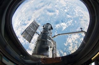 A view of the Hubble Space Telescope through the window of the shuttle Atlantis, which brought astronauts on a repair mission in 2009.