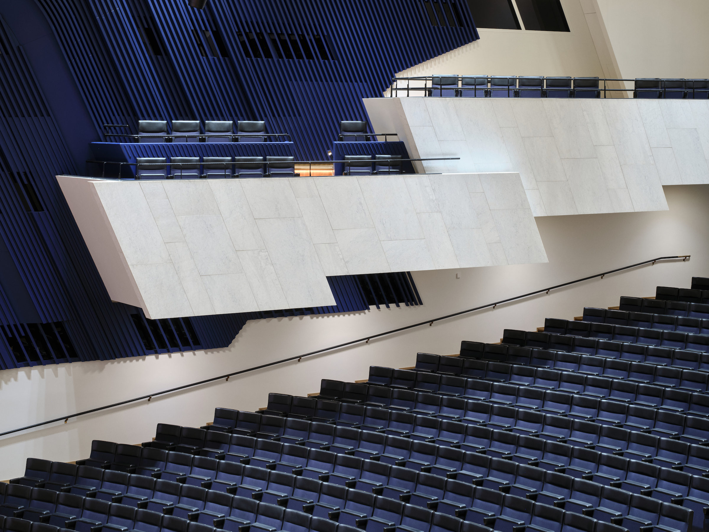 Large Finish concert space with deep blue seating and cladding, and pale concrete stonework.